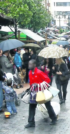 Un inmigrante vende bolsos en una zona peatonal de Oviedo. :: M. ROJAS/