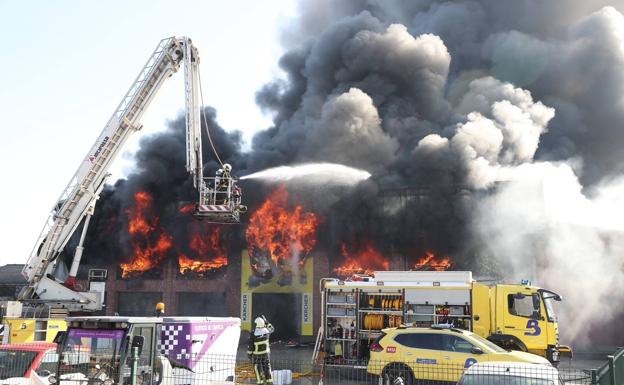 Un espectacular incendio calcina una nave industrial a las afueras de El Berrón